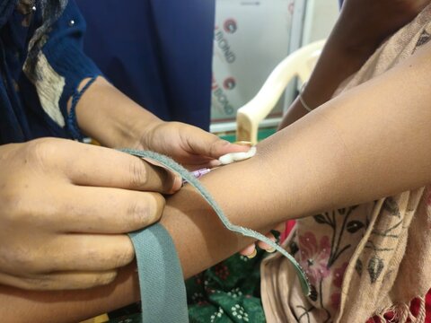 Medical technologist doing blood draw services for patient. Pathologist or lab assistant with sterile  taking blood sample from patient. India