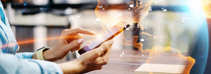 Close-up photo of female hands with smartphone. Concept of networking or remote work. Global...