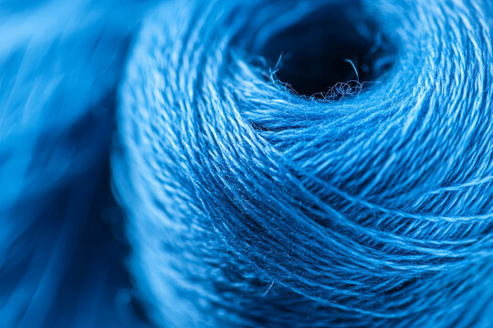 Close-up texture of blue sewing thread, macro background