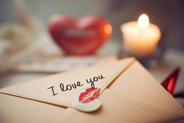 Love letter sealed with a kiss and a red lipstick mark