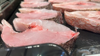 Fresh Fish for sale in the seafood market.Fresh fish for sale in a butcher shop.Fish meat on the stall. selling fresh fish in traditional market. traditional butcher stall.