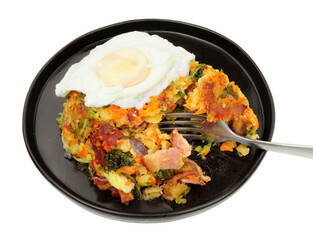 Portion of bubble and squeak a traditional British comfort food made with fried potatoes, cabbage and various left over food ingredients