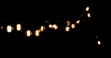 A string of lights is lit up in the dark