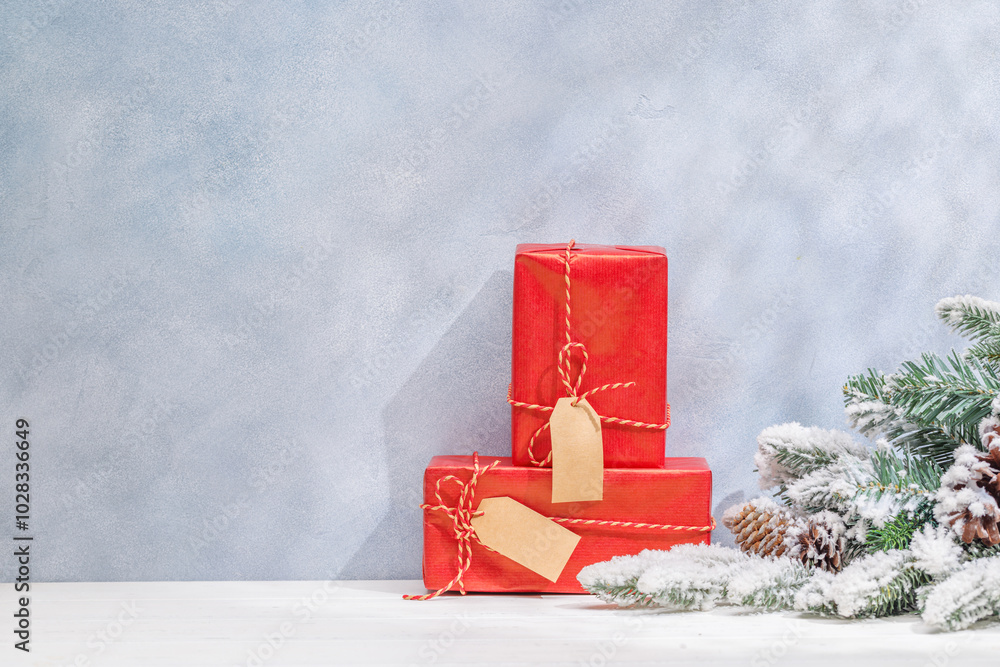 Aufkleber christmas template featuring gift boxes and snowy fir tree branches on a table with shadows and sun 