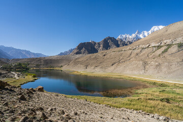 Colorful landscape view of Borith lake with Batura Muztagh mountains in background, near Hussaini, Hunza, Gilgit-Baltistan, Pakistan