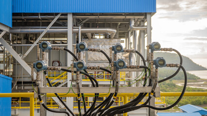 instrument transmitter measurement on power plant project. Close-up view of an industrial control panel with multiple sensors and gauges.