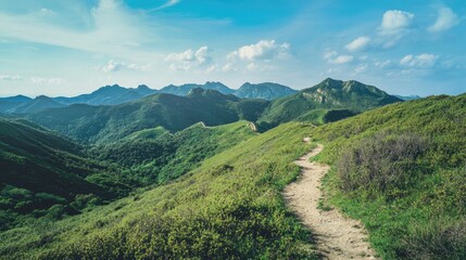 Scenic mountain view with a winding trail, lush green hills, and a clear blue sky, creating the perfect backdrop for outdoor adventure