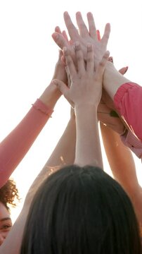 People, hands and high five for collaboration, team building and motivation with happy, women and flare. Group, huddle and outdoor for support, solidarity and success with cooperation, unity or trust