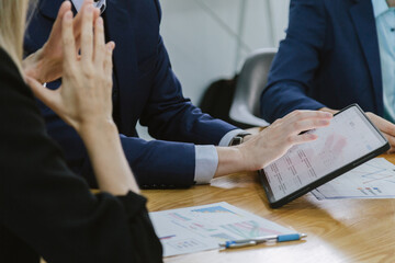 businessman and businesswoman team analyzing financial report and investment portfolio review. Professional mature fund broker with laptop and fact sheet of stock market investment analysis planning.