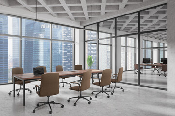 Stylish office interior with coworking and meeting zone, panoramic window