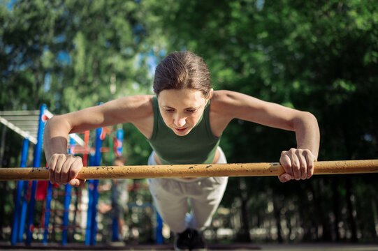 Mature woman doing push-ups in park