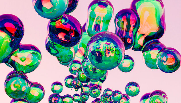 Multi colored bubbles in front of pink background