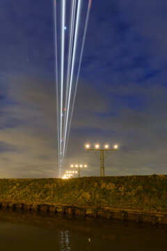 Airplane approaching at Amsterdam Schiphol airport under sky, Netherlands