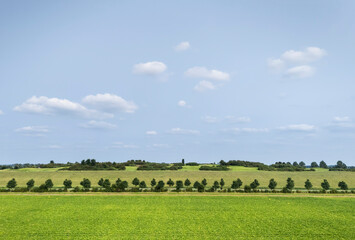 Golf course over artificial mountain under cloudy sky