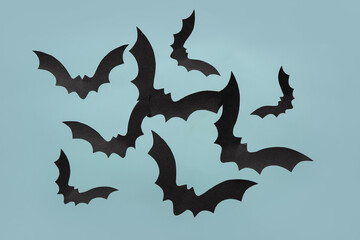 Paper bats for Halloween party on blue background