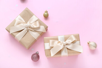 Christmas balls and gift boxes on pink background