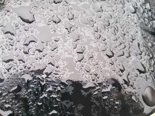 Water drops on glossy black background