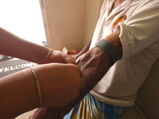 Pathologist or lab assistant with sterile taking blood sample from patient. Nurse taking Real Blood samples (Phlebotomist) for analysis from a patient. Selective focus, India.