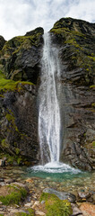 Vertical mountain panorama, waterfall in the Alps, Lombardy, Italy, Europe