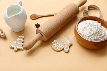 Delicious Christmas cookies, ingredients and utensils on color background