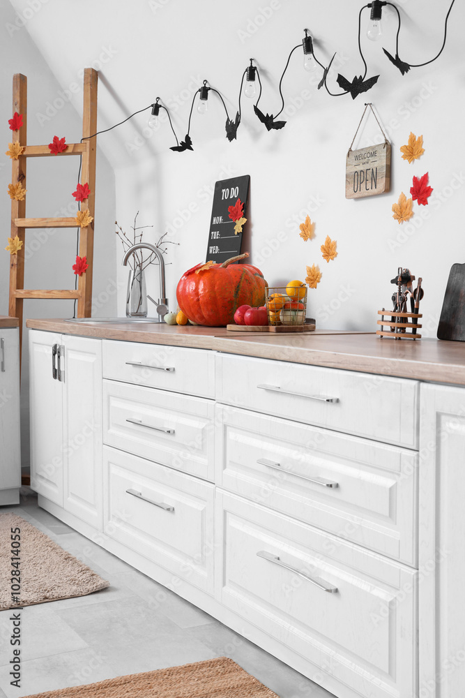 Wall mural Kitchen counters with utensils and Halloween decorations in festive kitchen