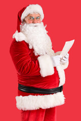 Santa Claus with letters on red background