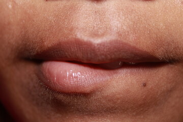 Teeth bitting lips a macro shot of Indian teenage girl mouth