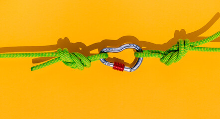 two ropes with secure knots are connected by a carabiner. Equipment for rock climbing and...