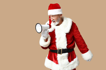 Santa Claus in glasses with megaphone screaming on brown background
