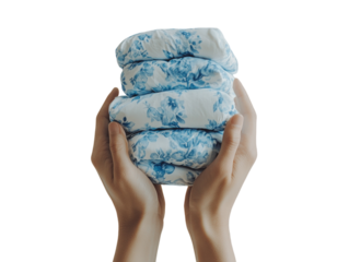 Hands holding a stack of folded clothes in blue and white, representing cleanliness and order, isolated on white background PNG transparent.