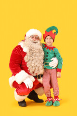 Santa Claus and cute little elf on yellow background
