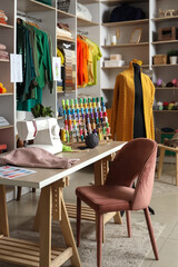 Interior of atelier with tailor's workplace, mannequin and shelves