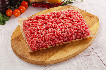 Raw minced beef meat over board