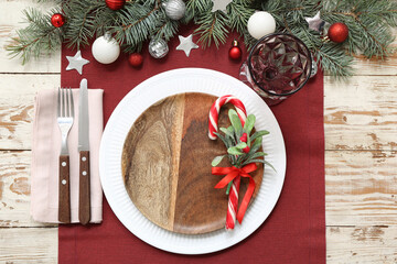 Beautiful Christmas table setting with decor on wooden background. Top view