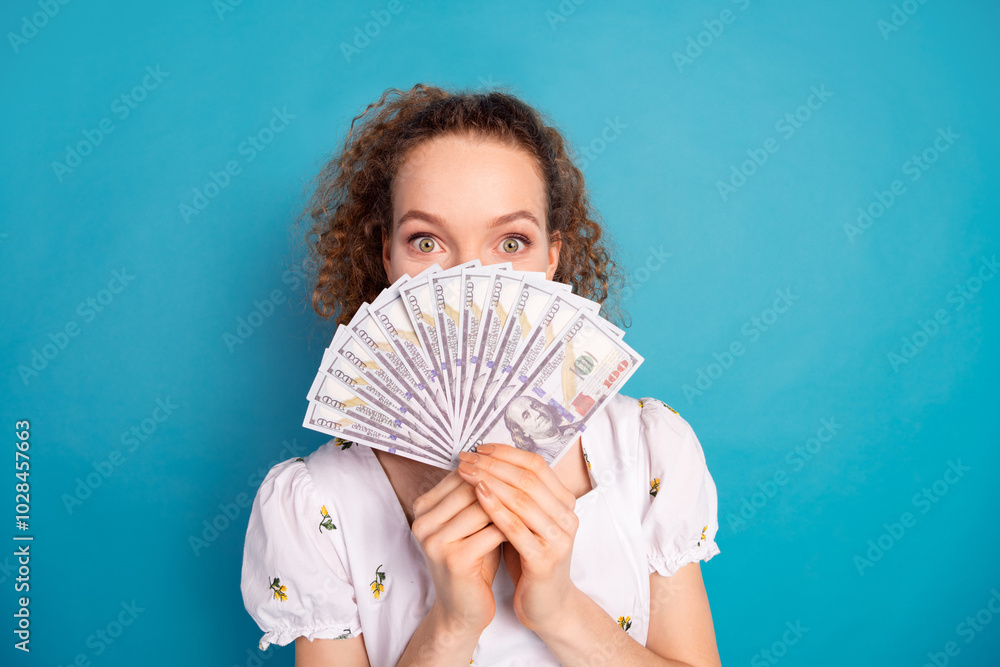 Poster Photo portrait of pretty young girl hold money fan cover hide face wear trendy white outfit isolated on blue color background