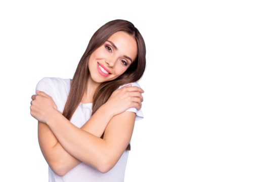 Portrait of nice youth touching her shoulders looking at camera wearing white t-shirt isolated over blue background