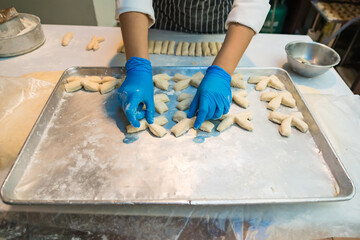 Blue-Gloved Hands Shaping Dough for Traditional Thai Fried Sticks