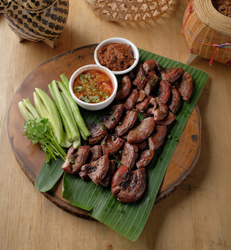 Roasted pork Chitterlings with chilli sauce spicy - entrails intestines part of pork asian thai food