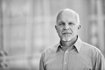 Senior businessman looking seriously in black and white