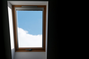 Window with a wooden frame and a blue sky outside