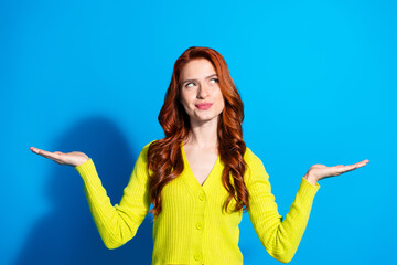 Photo portrait of attractive young woman compare hold look empty space dressed stylish yellow...