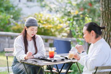 A Korean man and a Japanese woman, both in their 30s and a married couple, are enjoying an autumn brunch with three dogs at a stylish cafe located in Gyeongchun-ro, Namyangju-si, Gyeonggi-do, Korea.
