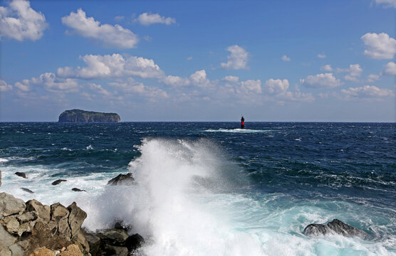Waves on rocks with the background of Jukdo Island near Jedong Port, Ulleung-gun, Korea
