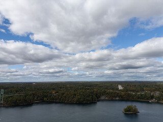 Aerial view of the serene 1000 Islands on the Canada side, showcasing lush, forested islands scattered across calm waters, ideal for nature enthusiasts and explorers.