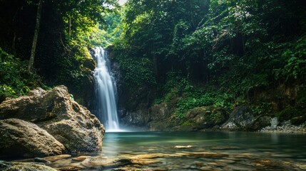 a beautiful waterfall cascading down rocks in a lush forest, symbolizing the beauty and power of nature