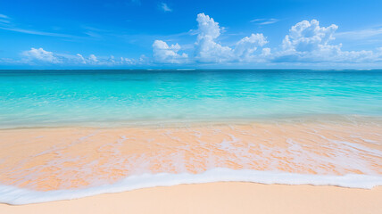 Tranquil turquoise water meets sandy beach under a blue sky.