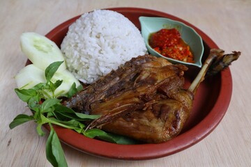 Penyet ayam or fried chicken in Indonesia is the name of a typical Javanese food consisting of fried chicken and chili sauce.