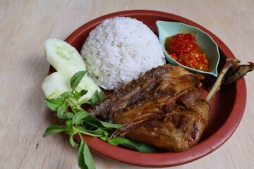 Penyet ayam or fried chicken in Indonesia is the name of a typical Javanese food consisting of fried chicken and chili sauce.