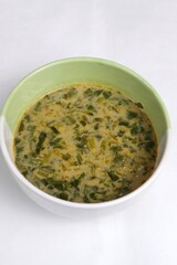 Spinach vegetable porridge is served in a bowl