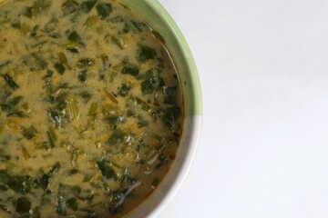 Spinach vegetable porridge is served in a bowl